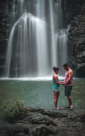 couple holding hands in front of Montezuma Waterfall