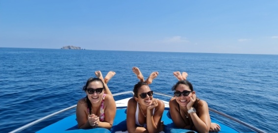 3 happy women on posing on boat