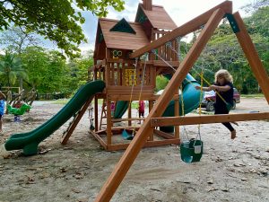 girl swinging on wing in playground