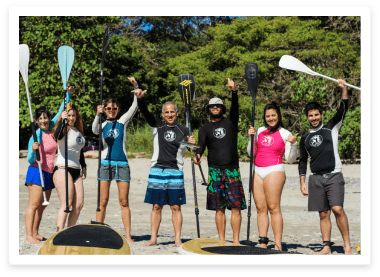 happy surf students with instructor